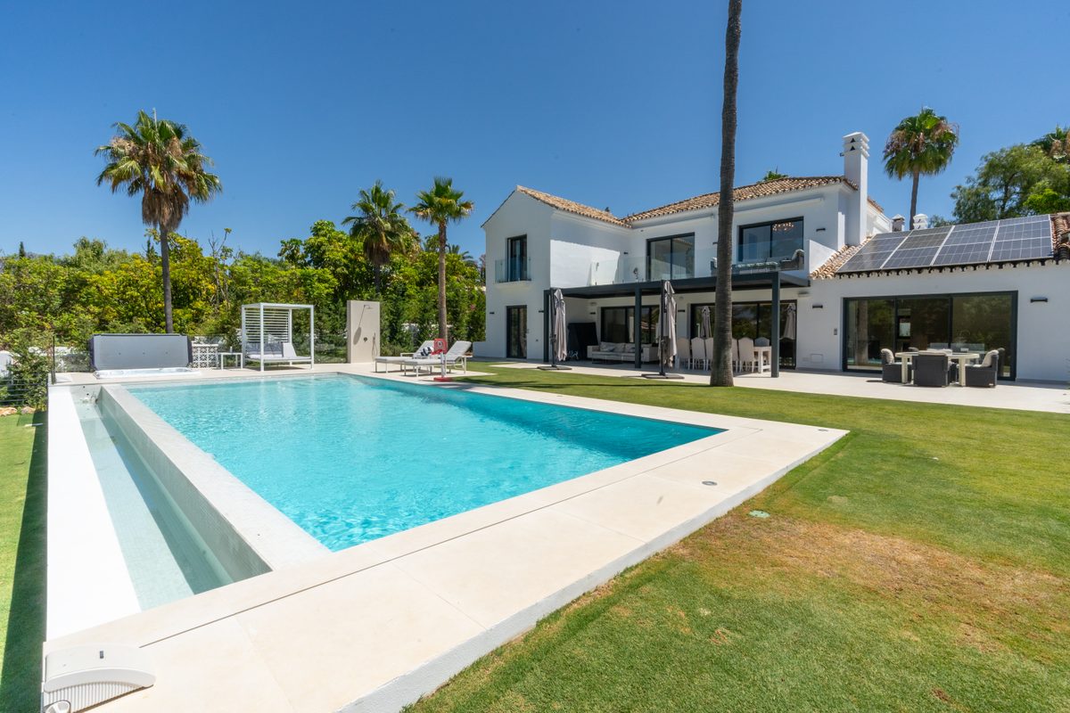 Private pool and villa facade with garden