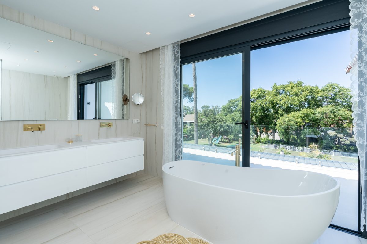 Master bathroom with freestanding bath and garden view