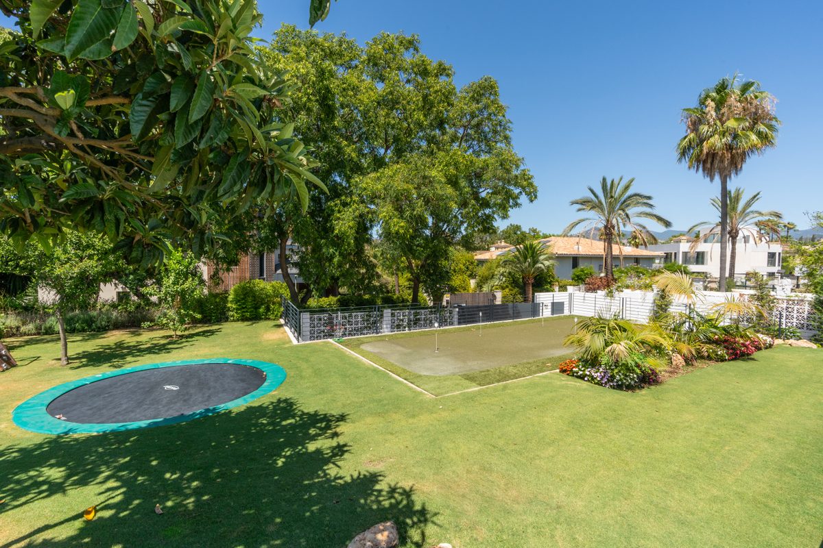 Large private garden with trampoline and lawn