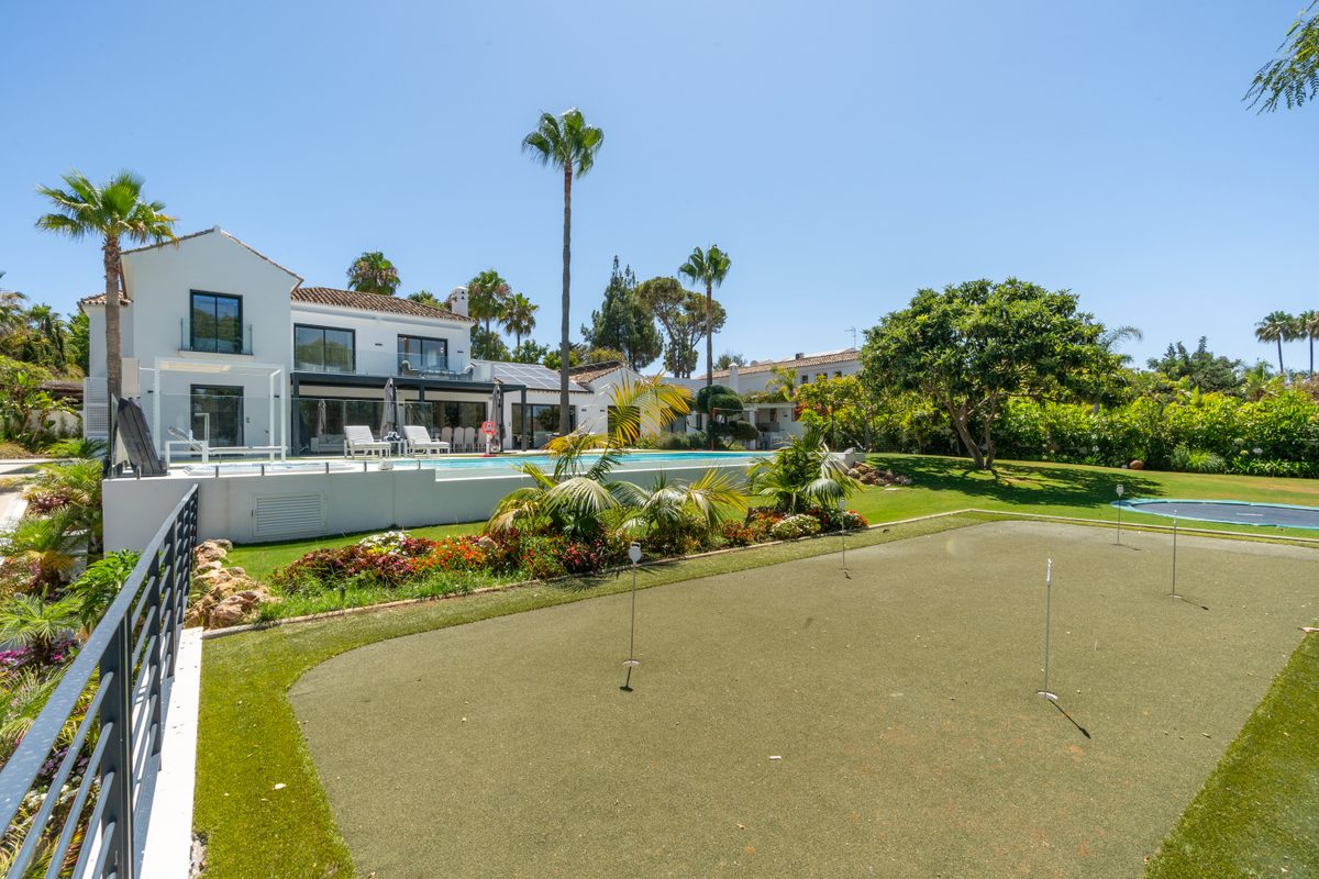Mini golf green with the villa behind